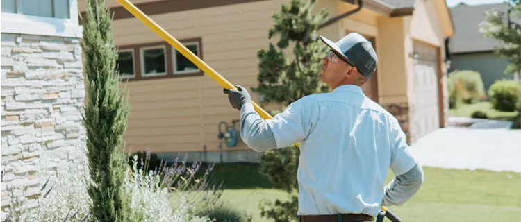 Midwest Pest tech cleaning home exterior for bugs