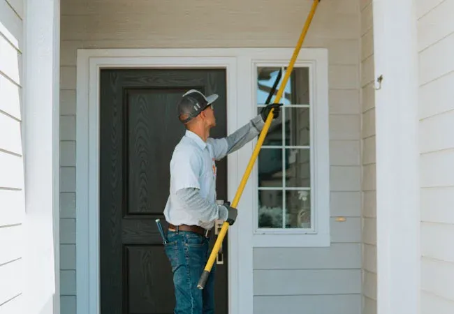 Tech cleaning entryway to home