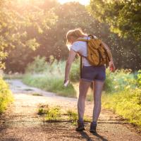 A Woman Walking along a Path Surrounded by Mosquitoes